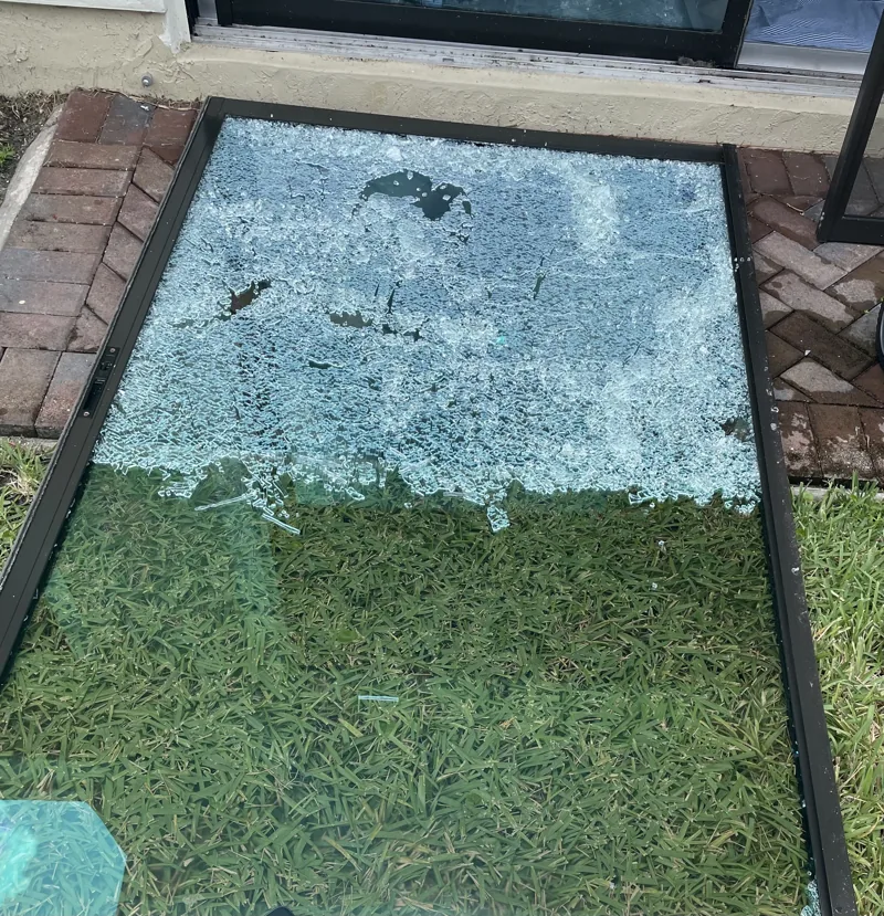 Shattered sliding door glass panel removed for clean-up