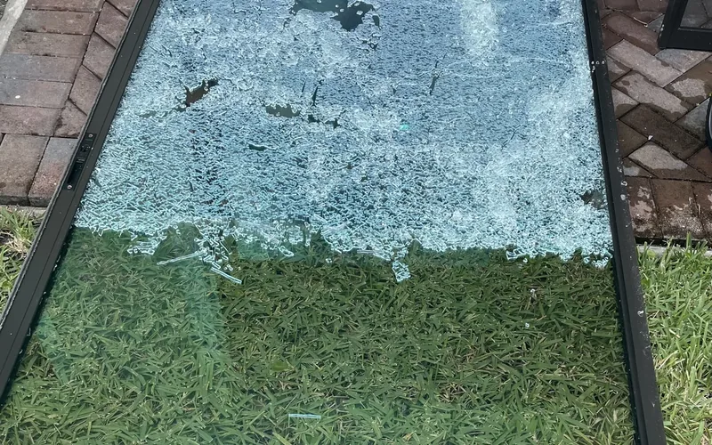 Shattered sliding door glass panel removed for clean-up