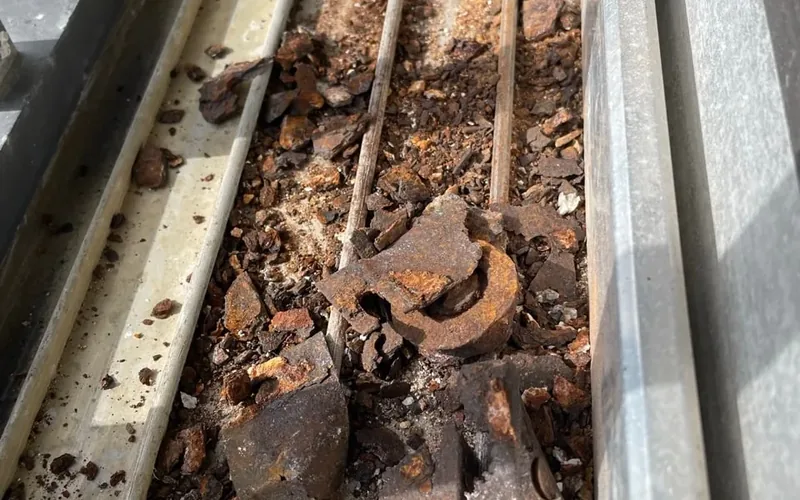 Corroded, debris-filled sliding door track from a Florida coastal home