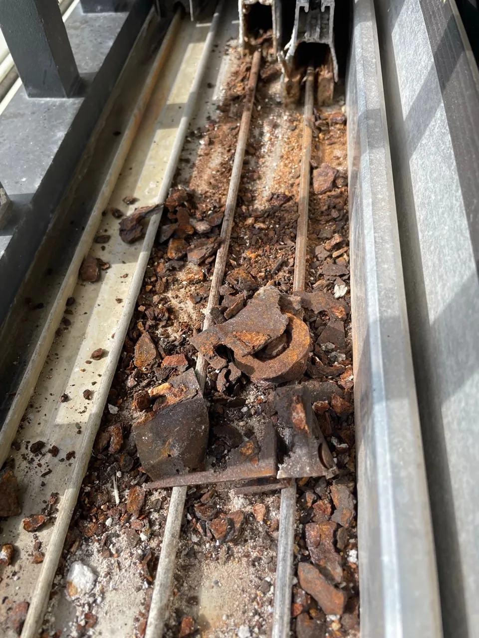 Corroded, debris-filled sliding door track from a Florida coastal home