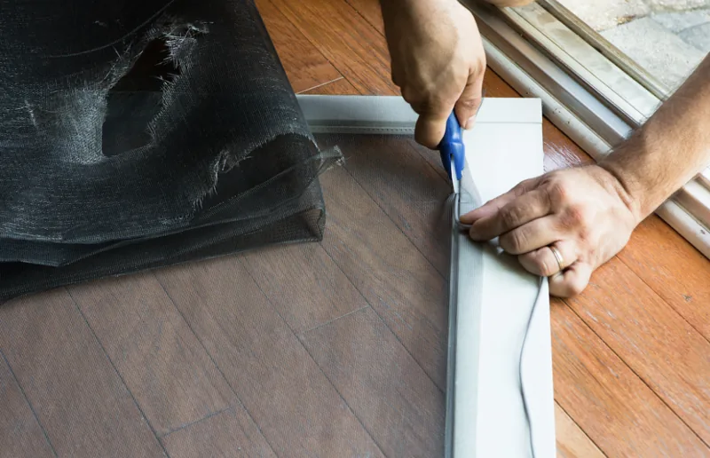 New fine-mesh screen fabric being fitted into a patio door frame