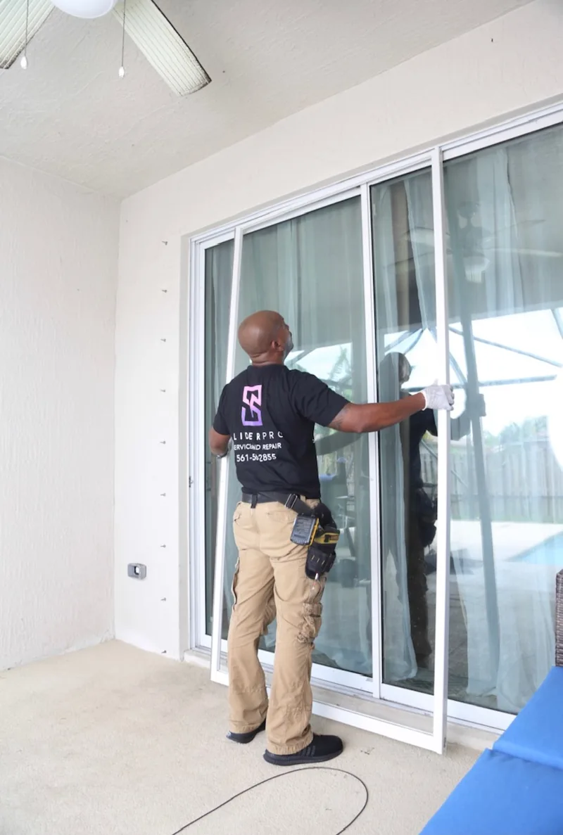 Technician checking sliding door latch and keeper alignment